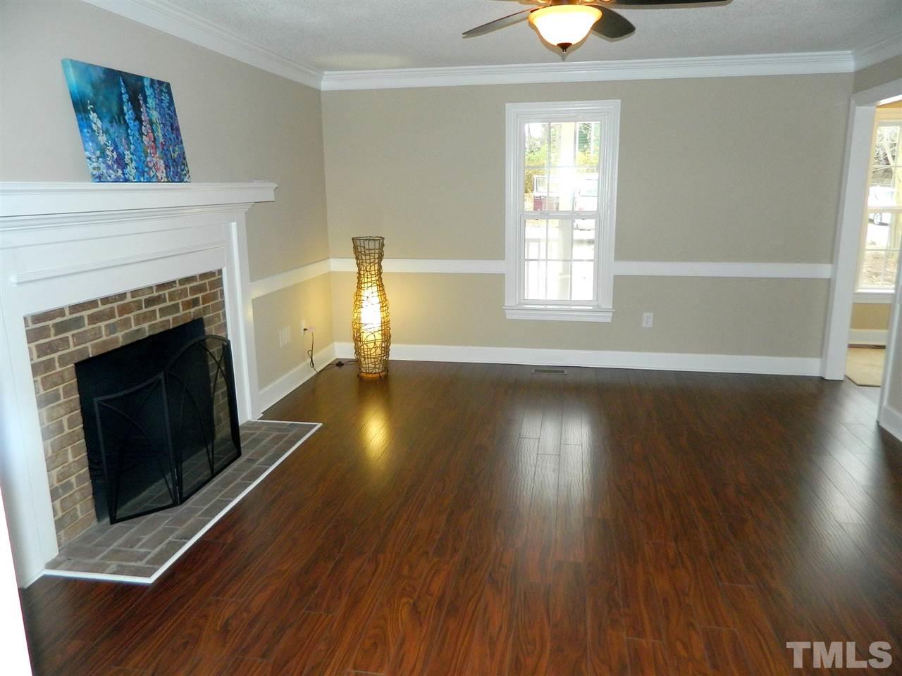 3824 Old Coach Road Raleigh, NC 27616 - Photo 2 of 25 a view of an empty room with wooden floor fireplace and a window