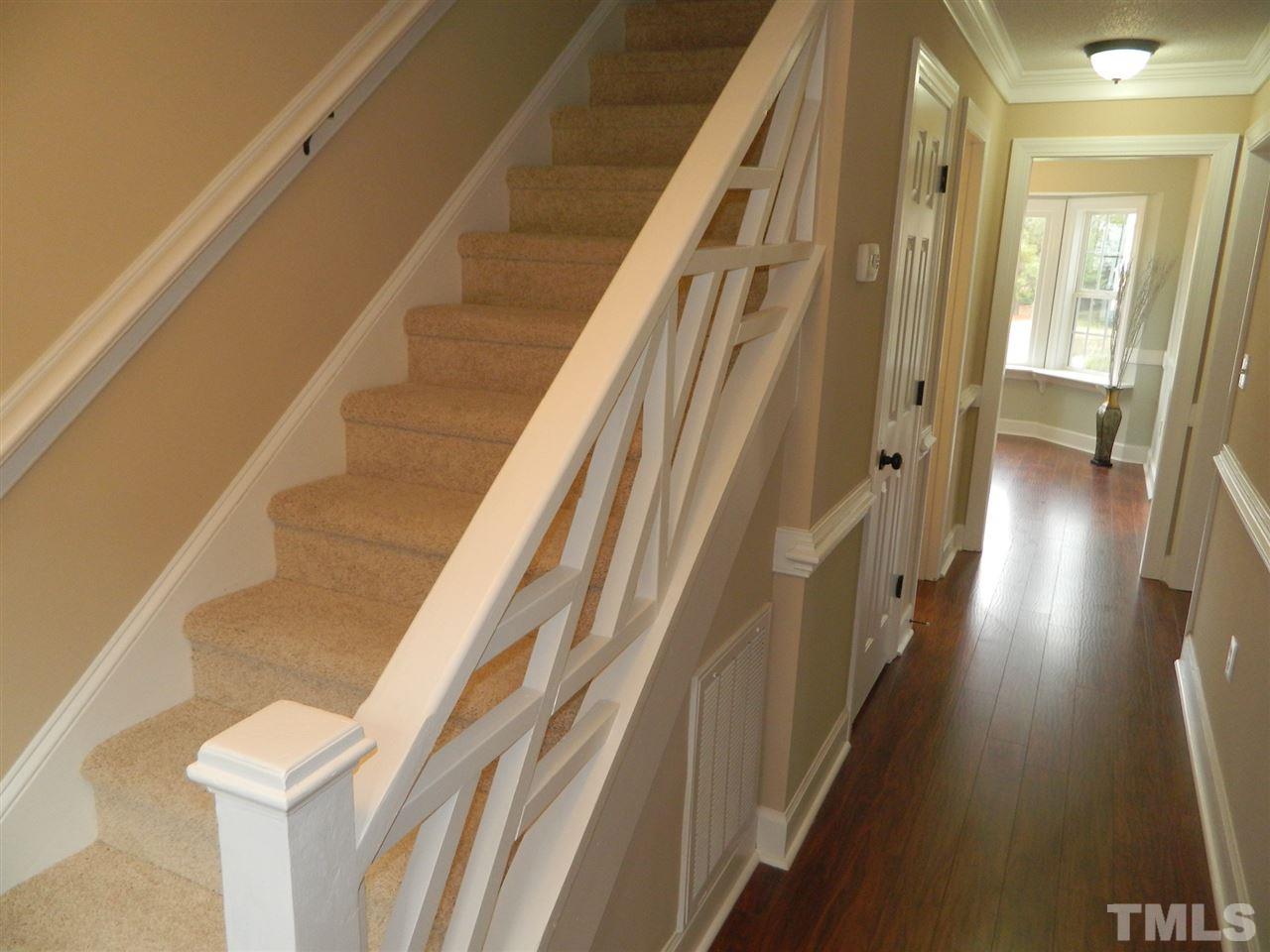 3824 Old Coach Road Raleigh, NC 27616 - Photo 12 of 25 a view of staircase with lots of frames on wall and a large window