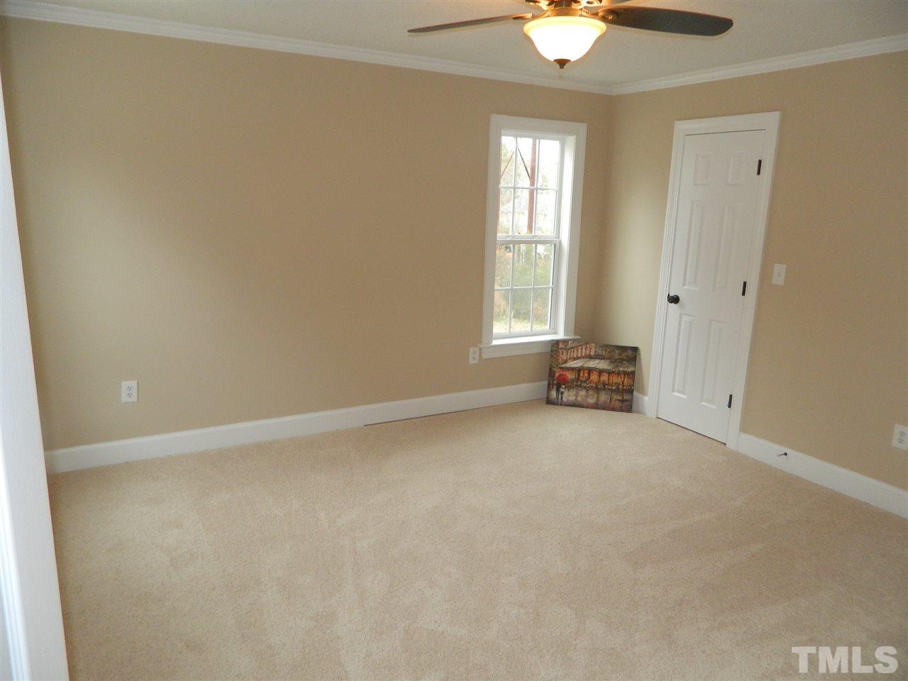 3824 Old Coach Road Raleigh, NC 27616 - Photo 14 of 25 an empty room with chandelier fan and windows