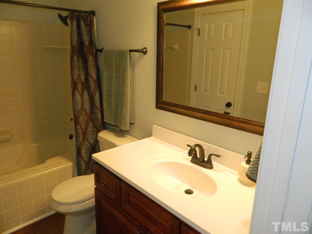 3824 Old Coach Road Raleigh, NC 27616 - Photo 15 of 25 a bathroom with a sink a toilet and shower