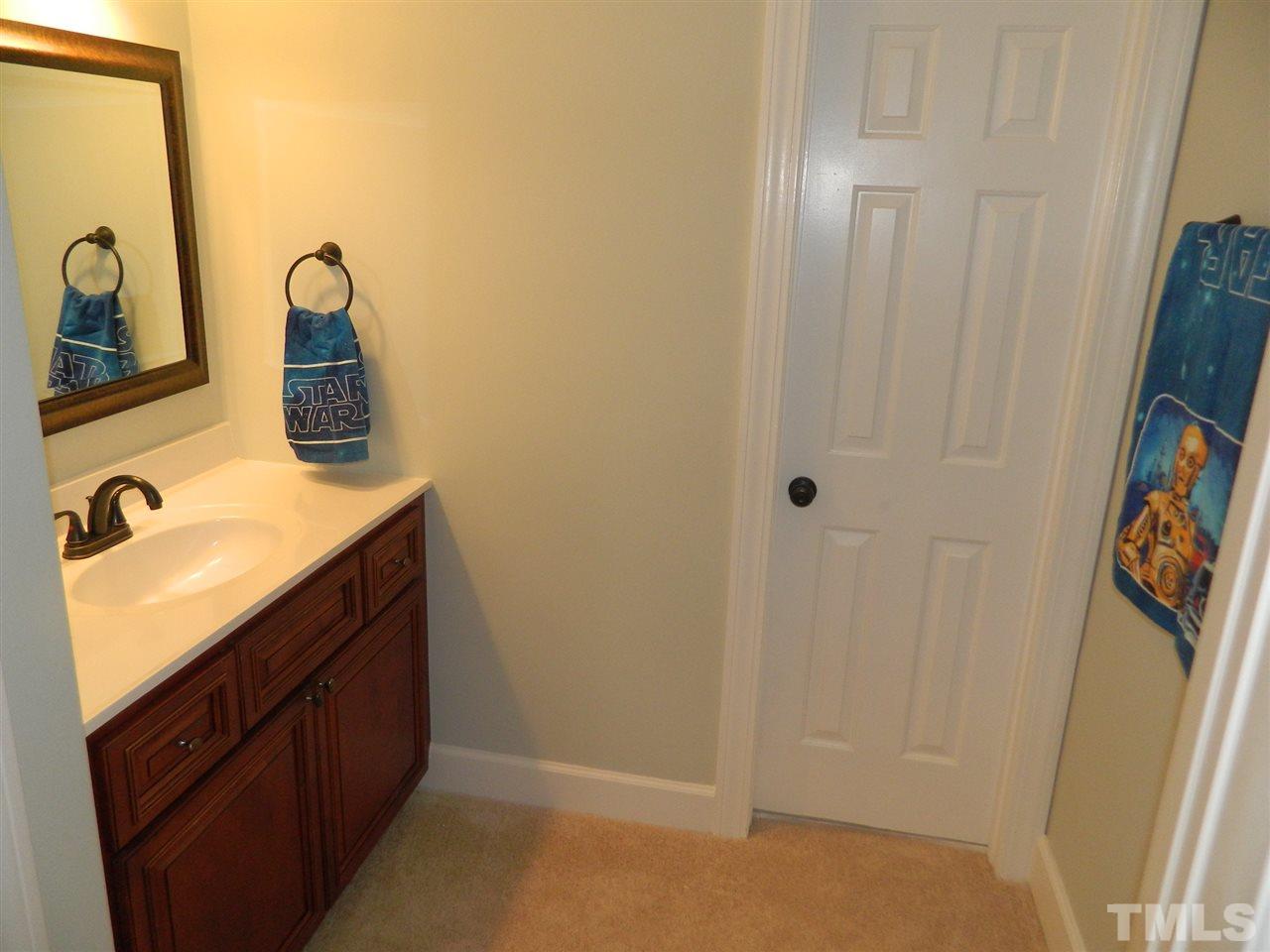 3824 Old Coach Road Raleigh, NC 27616 - Photo 20 of 25 a bathroom with a sink and mirror