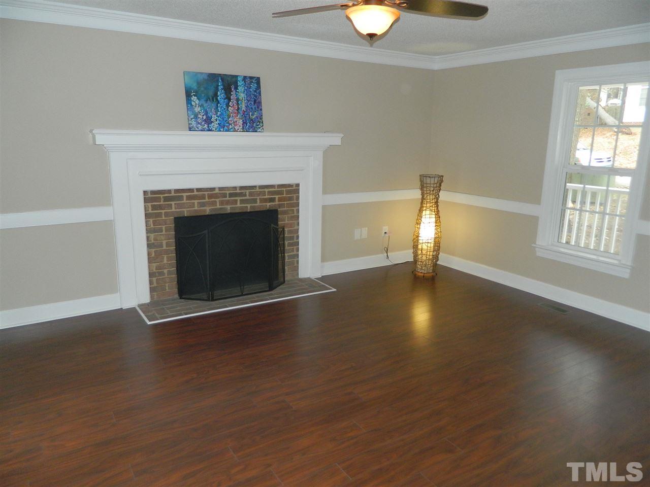 3824 Old Coach Road Raleigh, NC 27616 - Photo 3 of 25 a view of an empty room with window and wooden floor