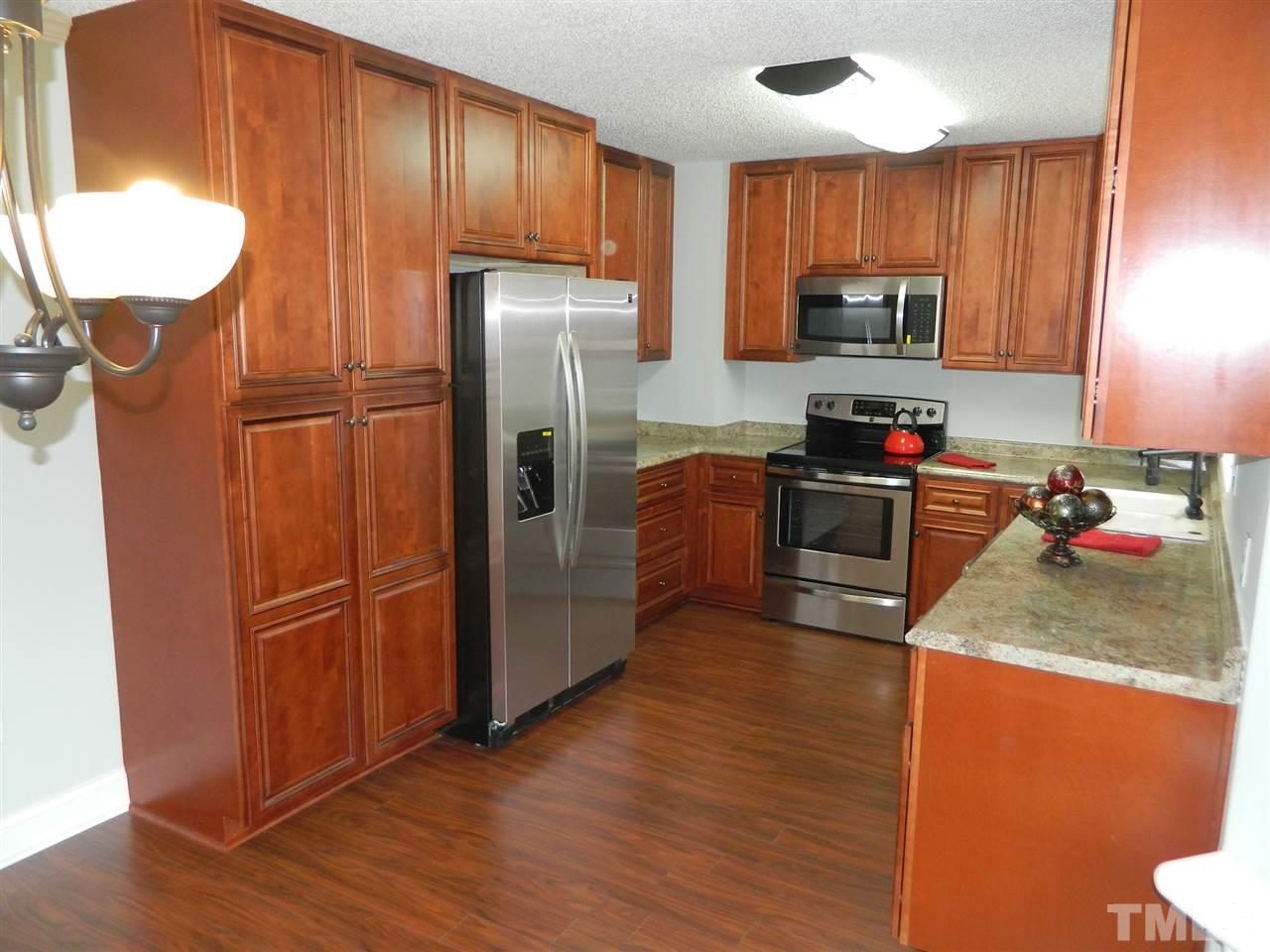 3824 Old Coach Road Raleigh, NC 27616 - Photo 5 of 25 a kitchen with stainless steel appliances granite countertop a refrigerator a stove top oven a sink and dishwasher