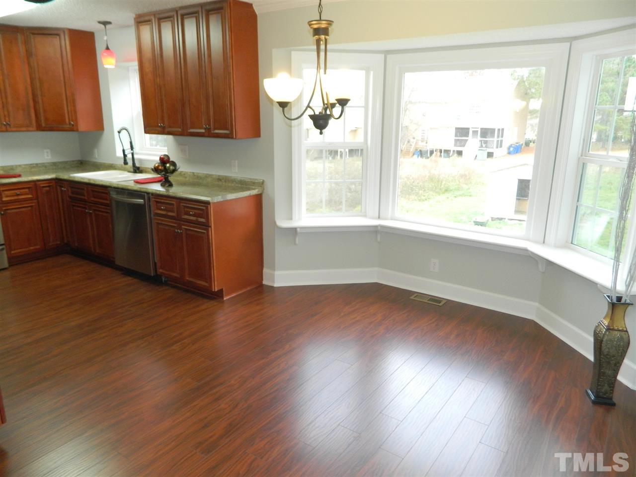 3824 Old Coach Road Raleigh, NC 27616 - Photo 7 of 25 a kitchen with wood floors and sink