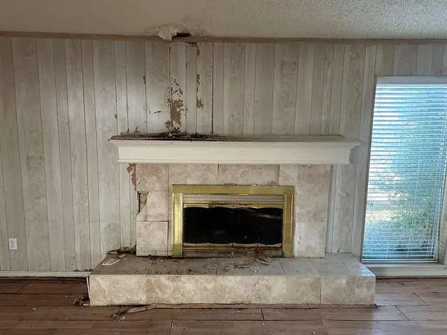 a living room with a fireplace and a fireplace