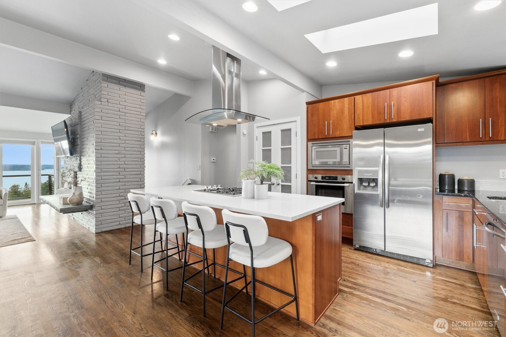 8620 Vashon View Southwest Seattle, WA 98136 - Photo 12 of 40 a kitchen with kitchen island a refrigerator and a dining table
