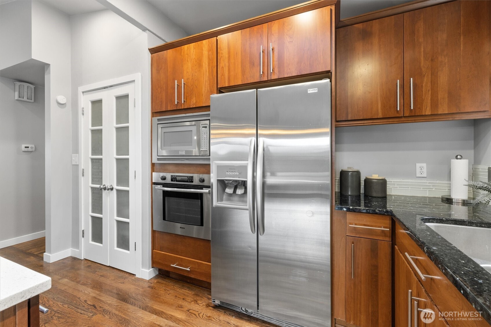 8620 Vashon View Southwest Seattle, WA 98136 - Photo 15 of 40 a kitchen with granite countertop stainless steel appliances a refrigerator and cabinets