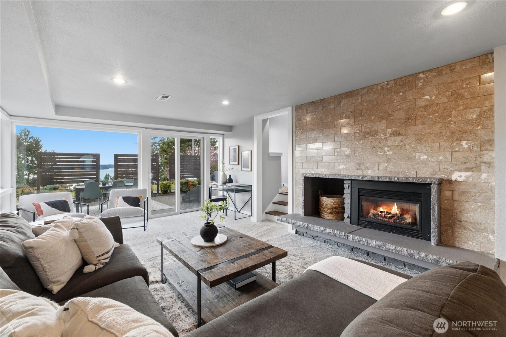 8620 Vashon View Southwest Seattle, WA 98136 - Photo 26 of 40 a living room with furniture a fireplace and a large window