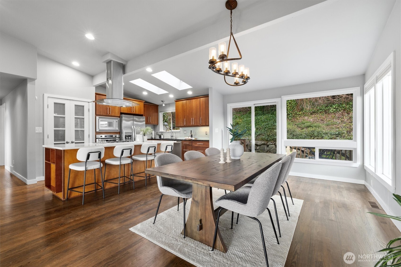 8620 Vashon View Southwest Seattle, WA 98136 - Photo 10 of 40 a view of a dining room with furniture wooden floor and chandelier