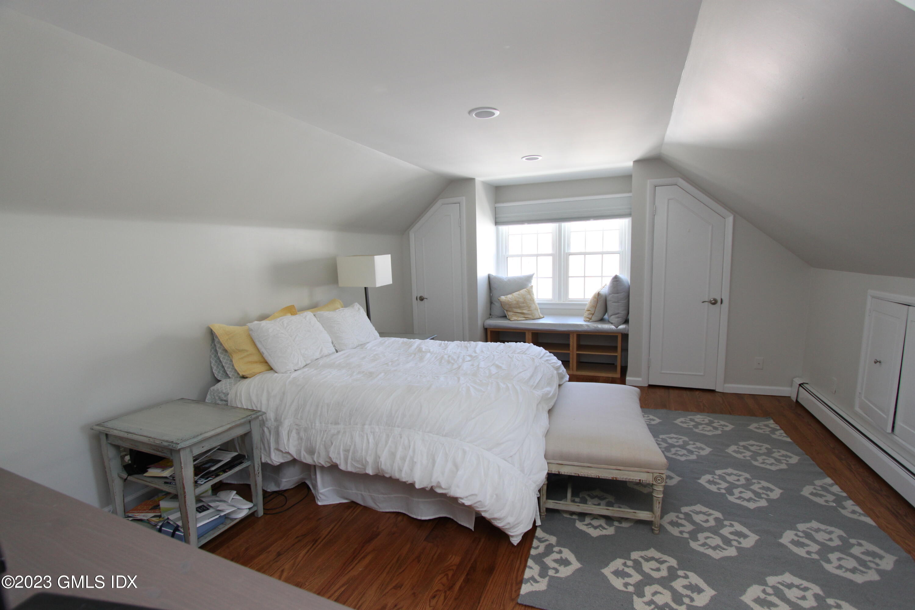 11 Manor Road Old Greenwich, CT 06870 - Photo 11 of 19 a bedroom with a bed and wooden floor