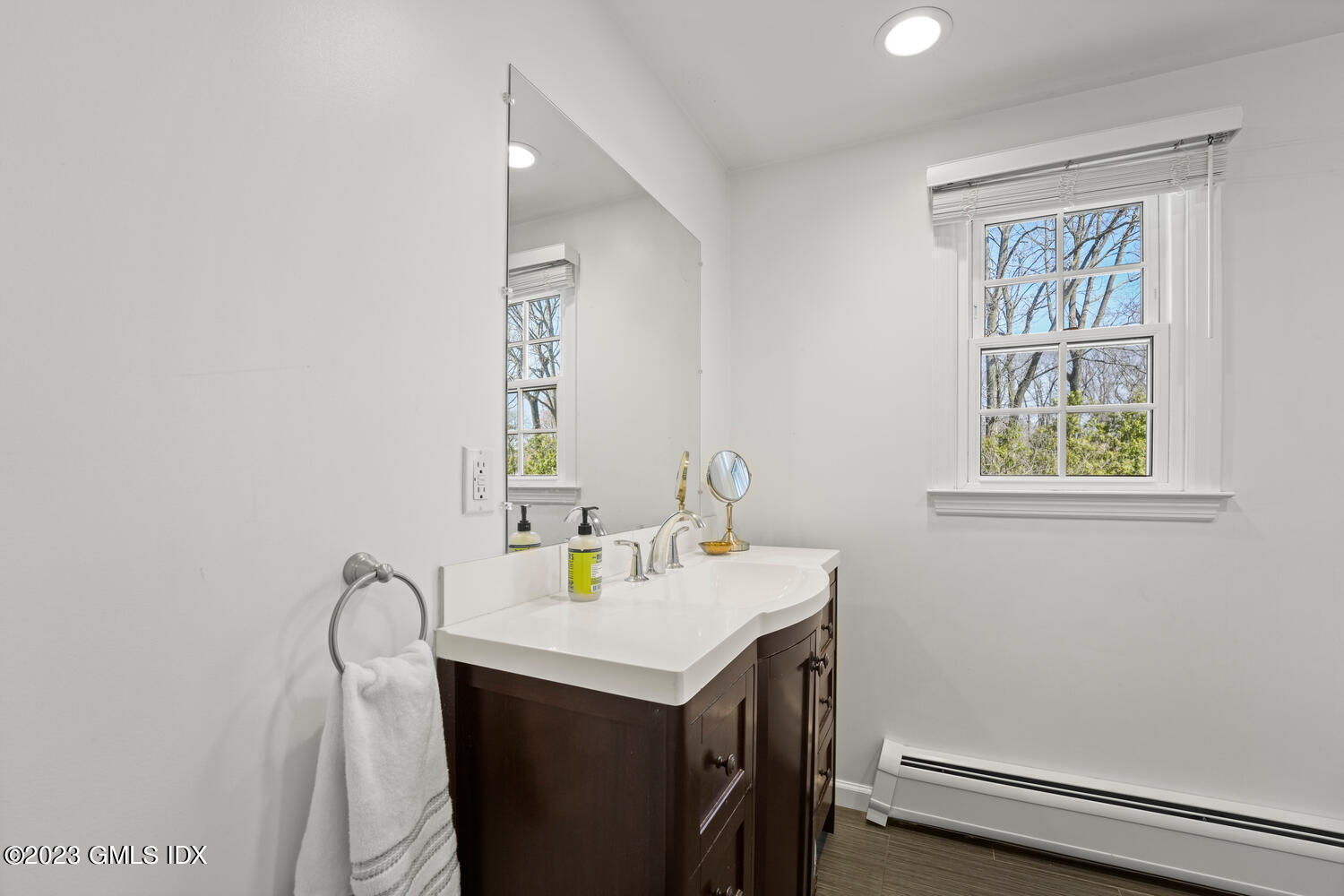 11 Manor Road Old Greenwich, CT 06870 - Photo 12 of 19 a bathroom with a sink vanity and a mirror