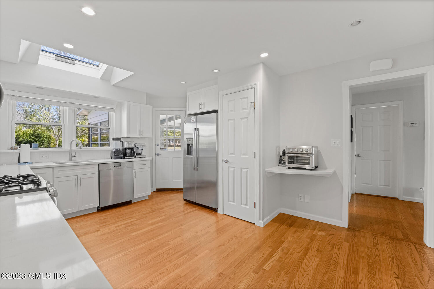 11 Manor Road Old Greenwich, CT 06870 - Photo 4 of 19 a kitchen with white cabinets and refrigerator