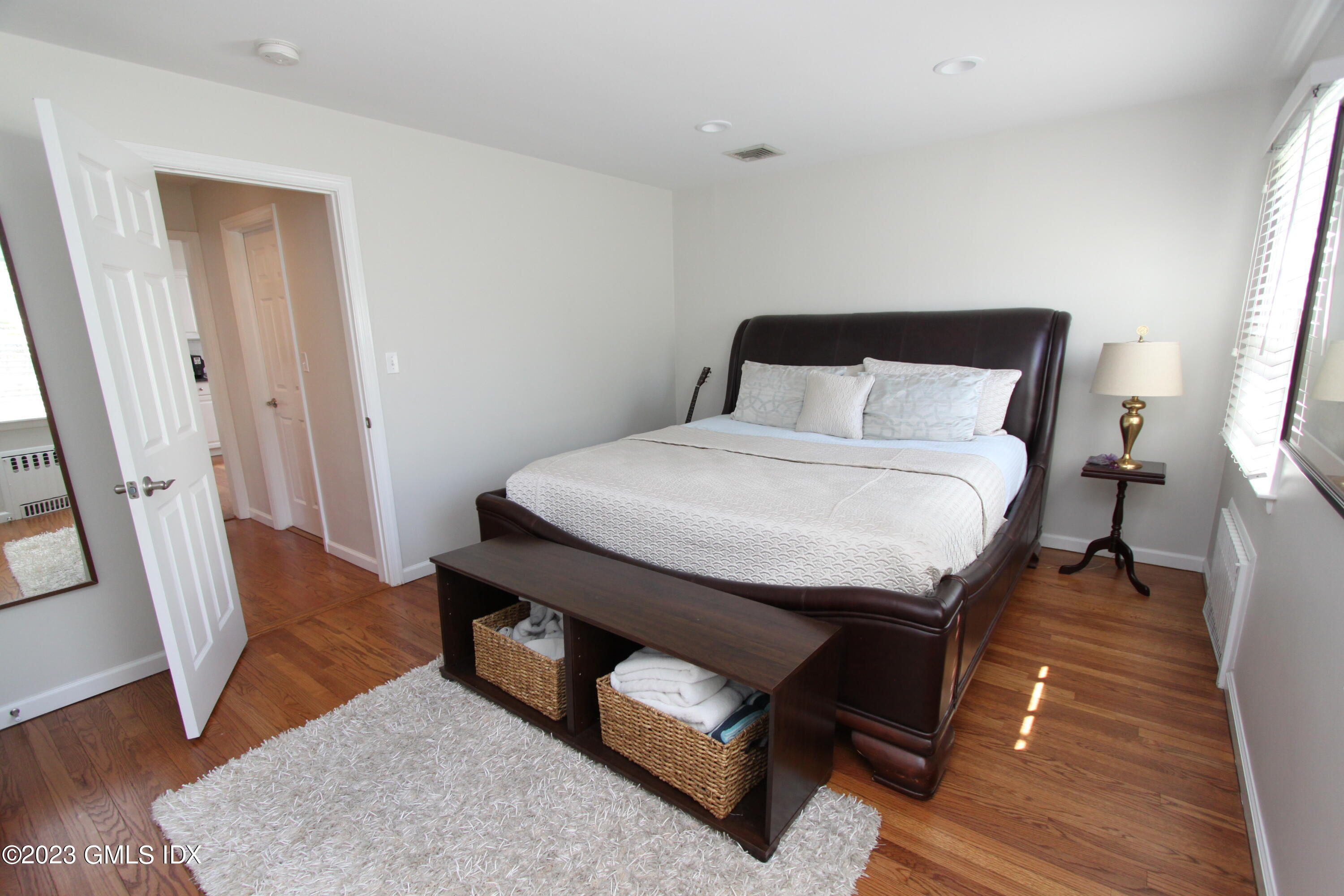 11 Manor Road Old Greenwich, CT 06870 - Photo 8 of 19 a bedroom with a bed and wooden floor