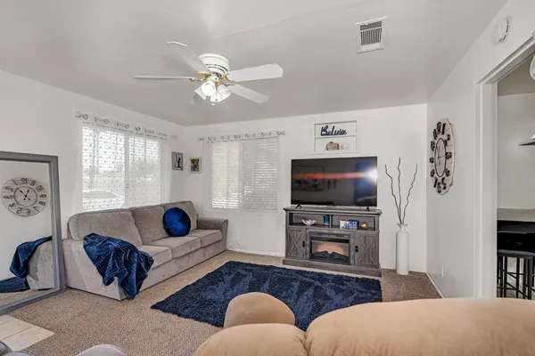 a living room with furniture and a flat screen tv