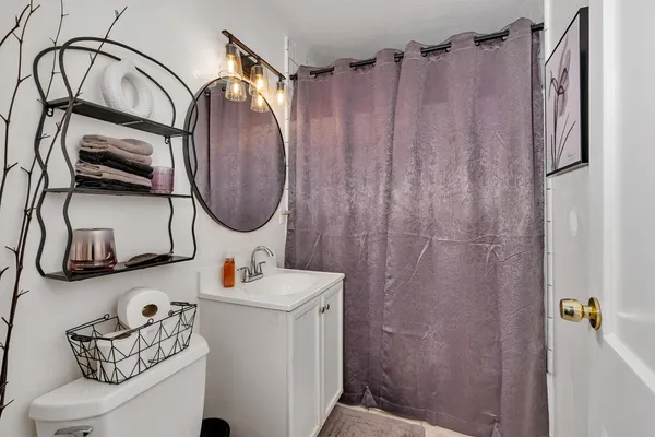 a bathroom with a sink toilet and shower