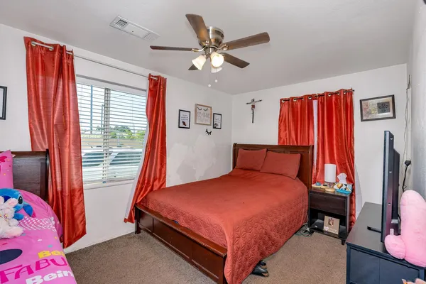 a bedroom with a bed and a window