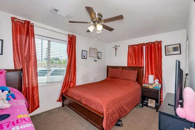 a bedroom with a bed and a window