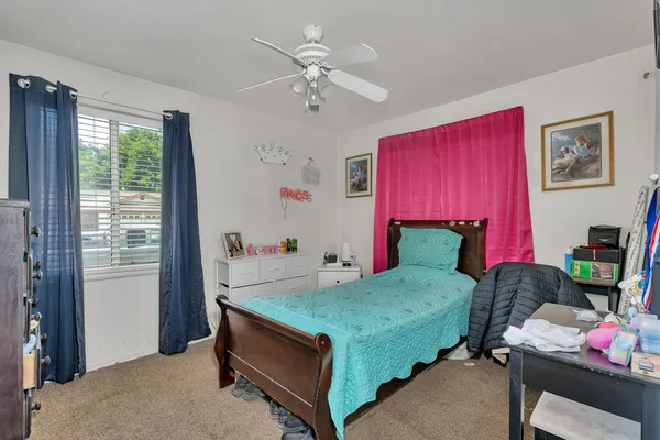 a bedroom with a bed and a window