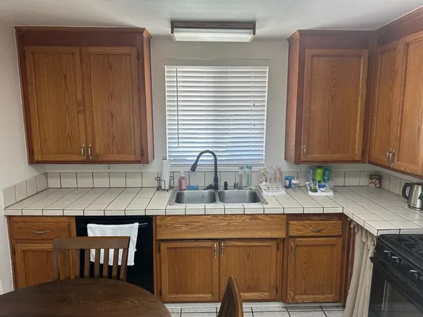 a kitchen with stainless steel appliances granite countertop a sink and cabinets