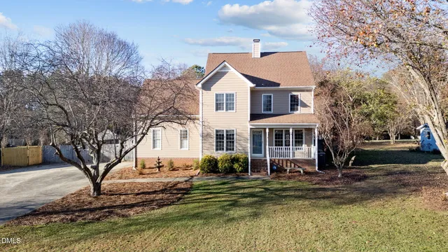 a view of a house with a yard covered in snow
