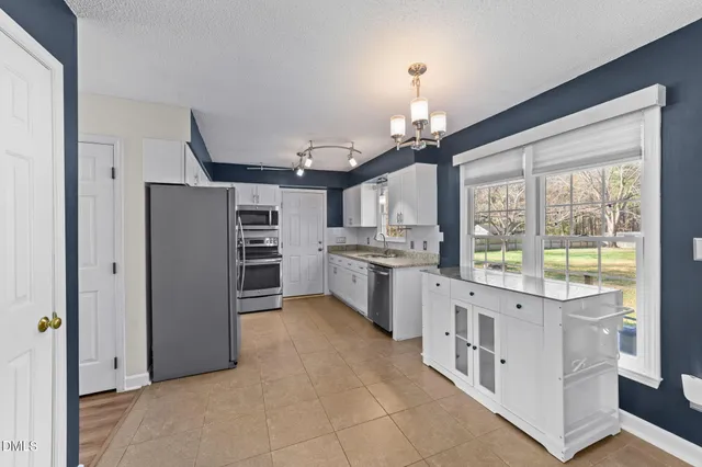 a room with painting on the wall and a window