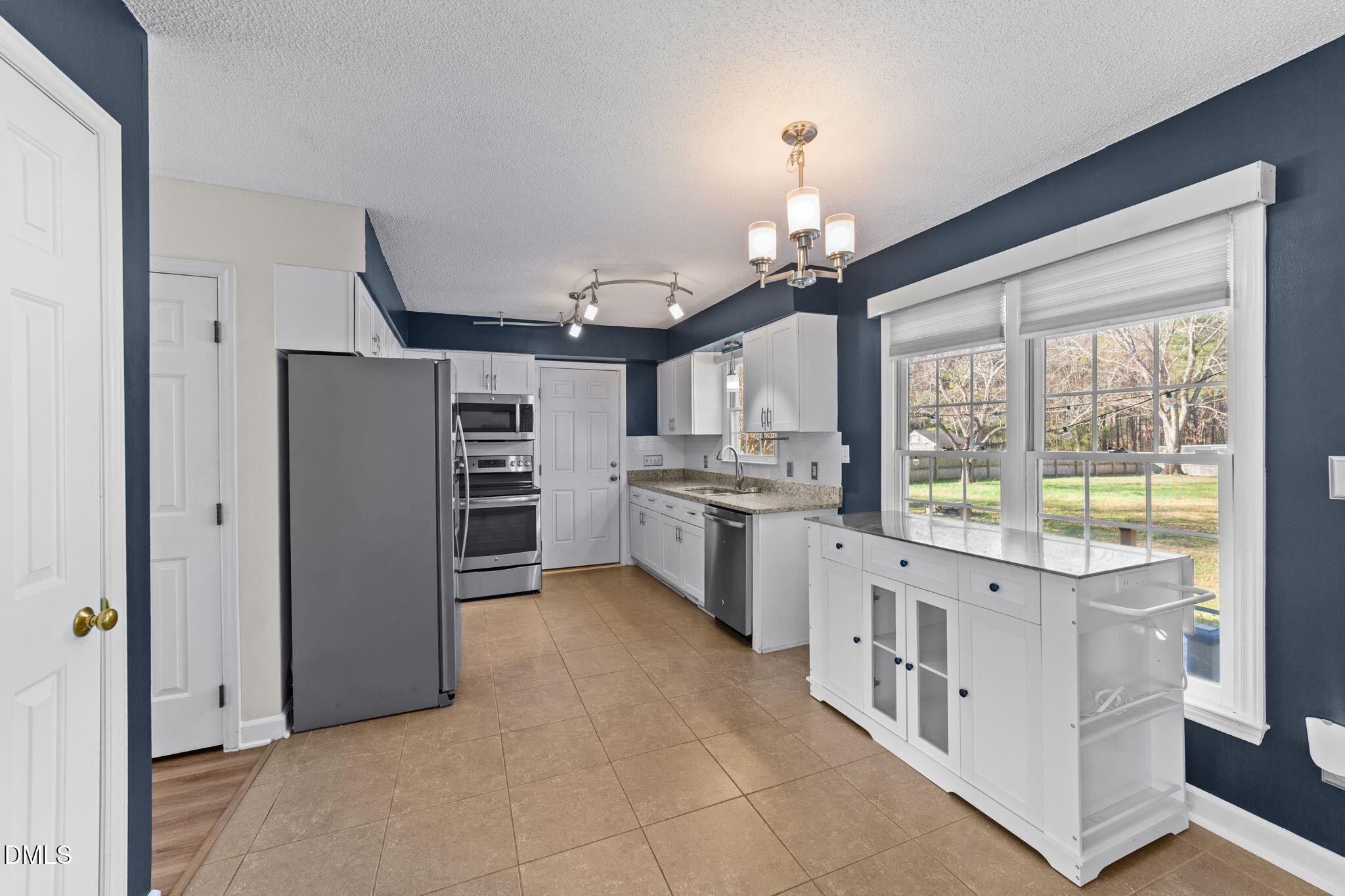 1030 Loop Road Clayton, NC 27527 - Photo 6 of 20 a open kitchen with stainless steel appliances granite countertop a stove and a refrigerator