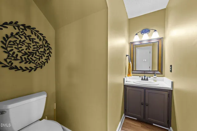 a kitchen with stainless steel appliances granite countertop a stove top oven a sink and a refrigerator