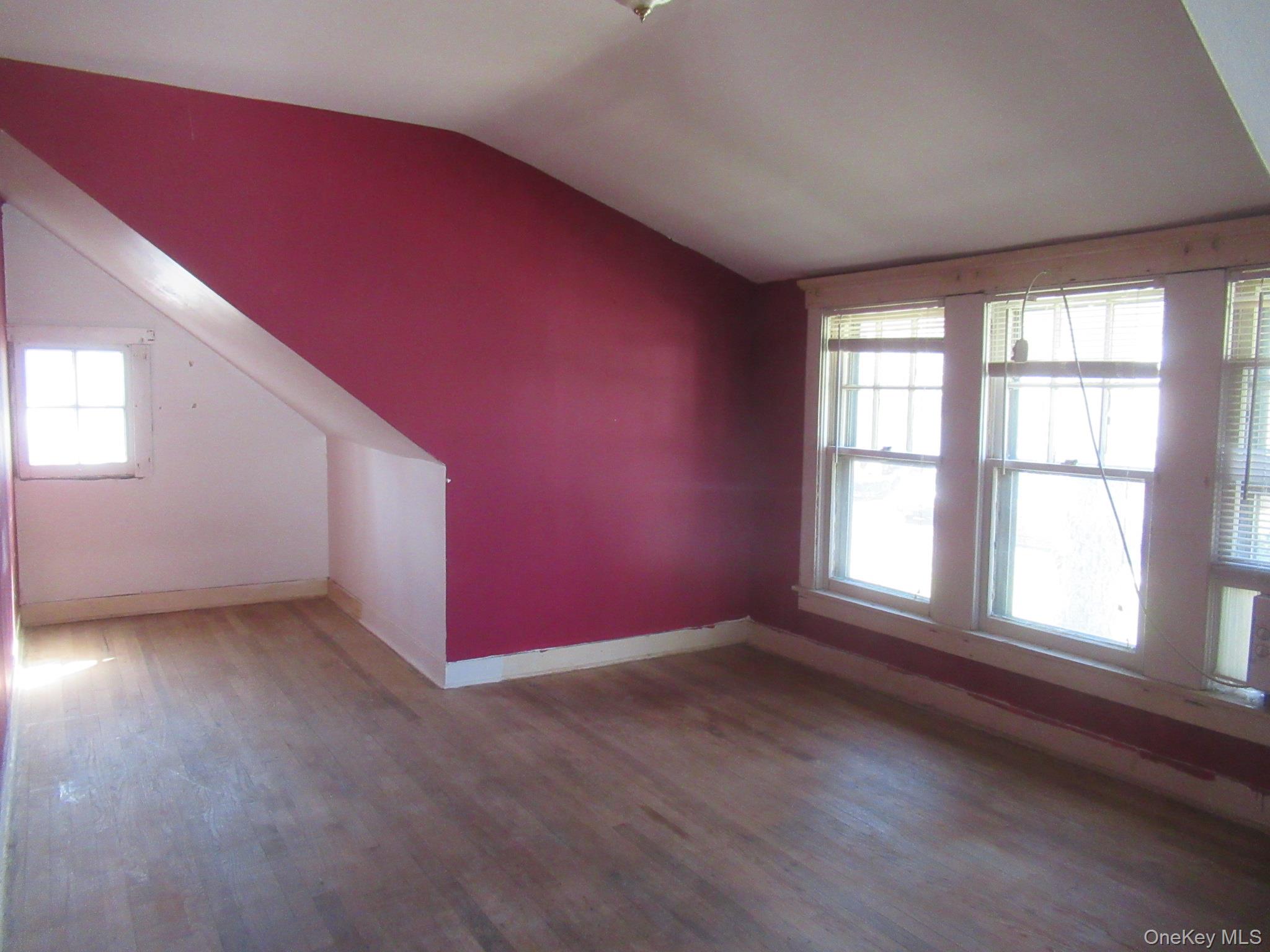 72 Waterstone Road Greenwood Lake, NY 10925 - Photo 15 of 20 Room with wood-finish flooring, a sloped ceiling, and multiple windows