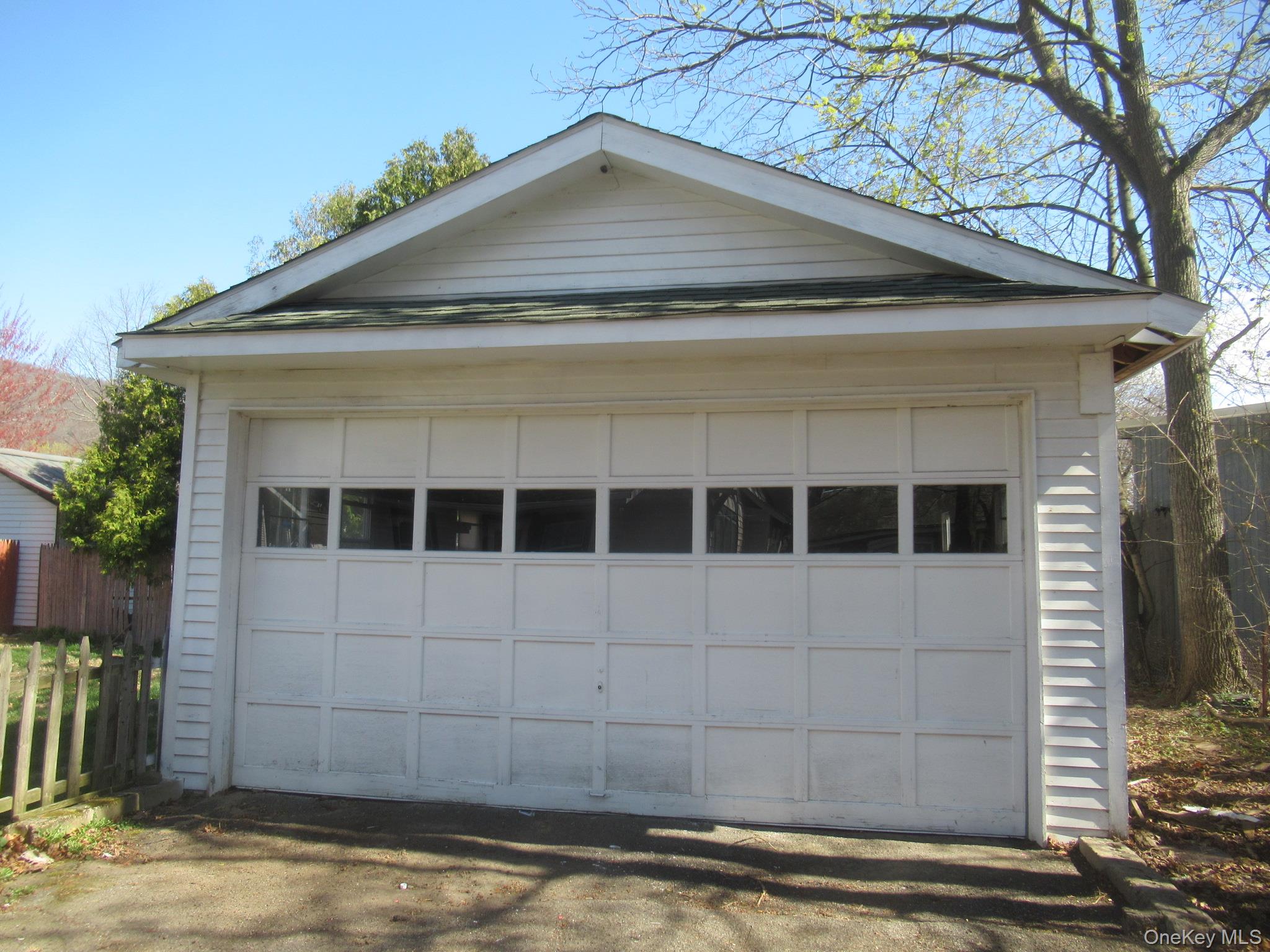 72 Waterstone Road Greenwood Lake, NY 10925 - Photo 18 of 20 Detached garage with horizontal siding, a gabled roofline, and a panel garage door featuring upper rectangular windows