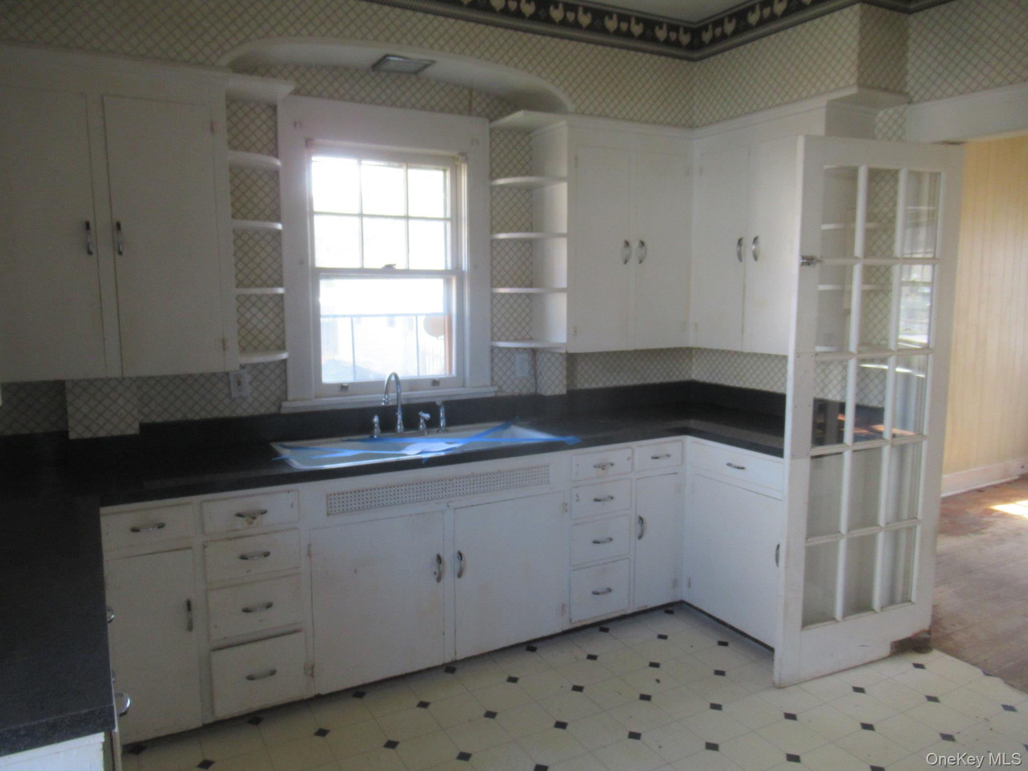 72 Waterstone Road Greenwood Lake, NY 10925 - Photo 4 of 20 Corner kitchen featuring extensive white cabinetry with shelving,with window above the sink
