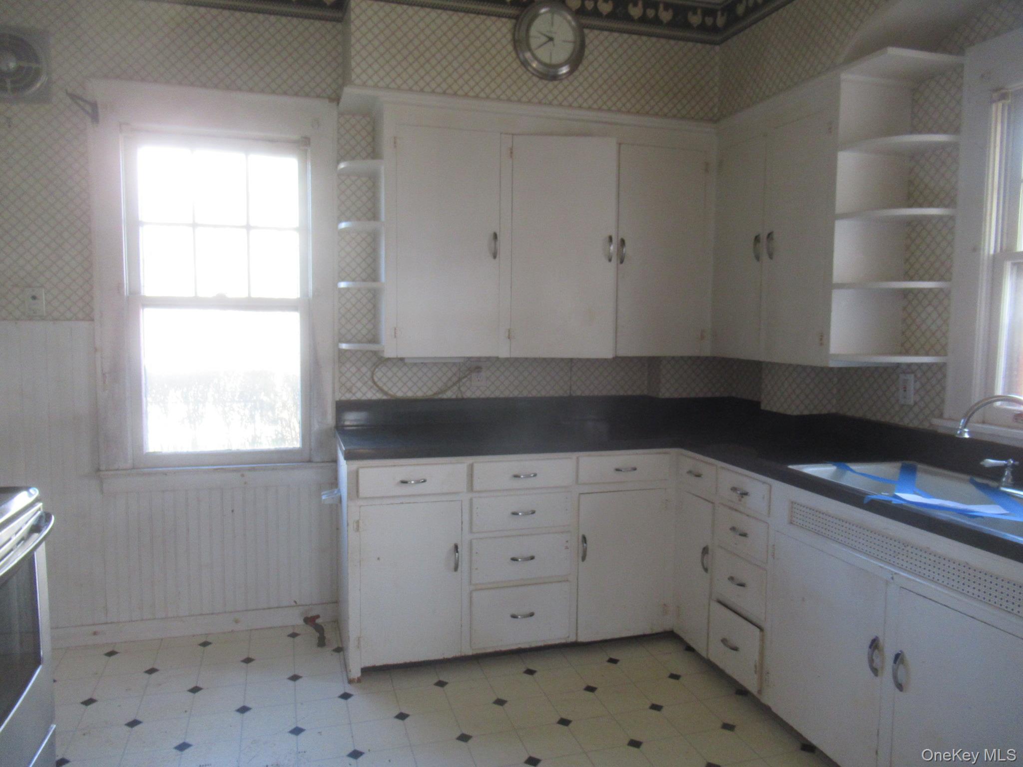 72 Waterstone Road Greenwood Lake, NY 10925 - Photo 5 of 20 White cabinetry with dark countertops, built-in corner shelving