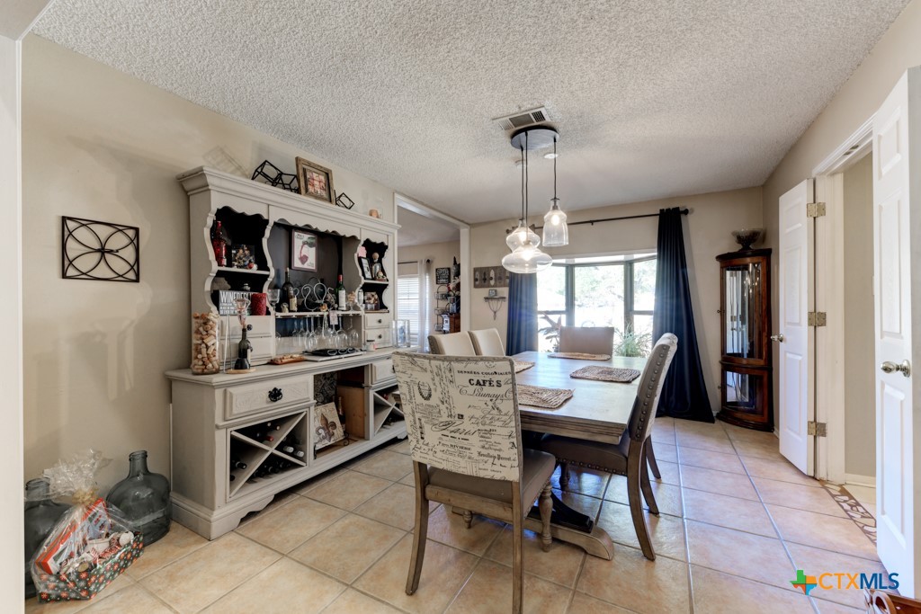 1229 Rapids Road New Braunfels, TX 78130 - Photo 7 of 27 a view of a dining room with furniture