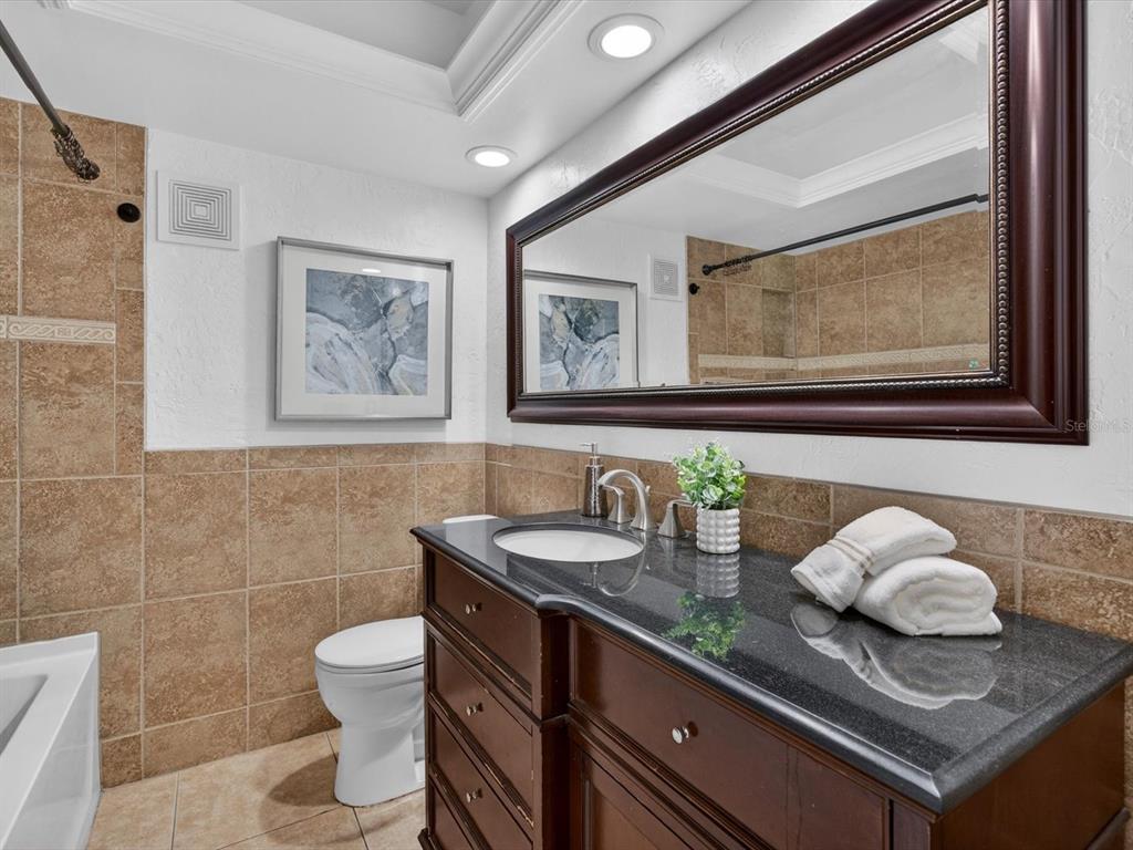 333 Cornwall Road Winter Park, FL 32792 - Photo 22 of 32 a bathroom with a granite countertop sink and a mirror