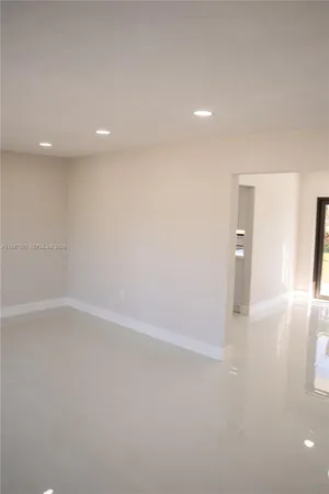 a kitchen with granite countertop a stove a sink and a microwave