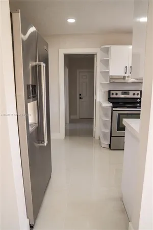 a kitchen with white cabinets and a sink