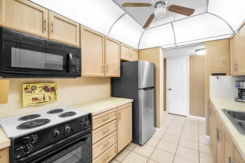 a kitchen with a stove cabinets and refrigerator