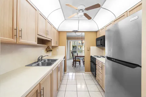a kitchen with stainless steel appliances granite countertop a sink a stove and refrigerator
