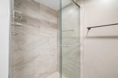 a bathroom with a glass shower door
