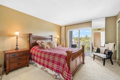 a bedroom with a bed a lamp and a window