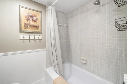 a bathroom with a bathtub and a shower
