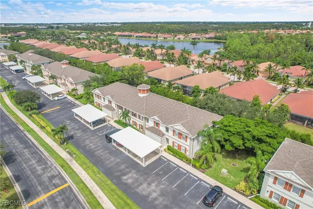 an aerial view of residential houses with outdoor space and river