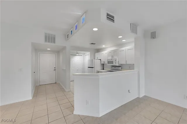 a view of kitchen with center island and stainless steel appliances