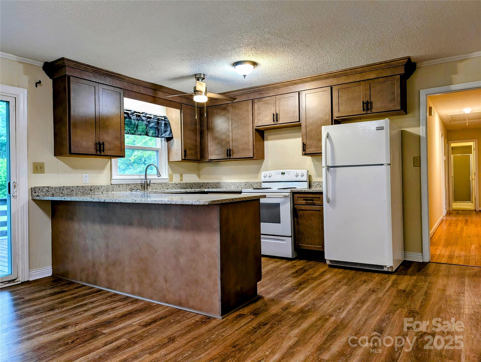5628 White Store Road Wingate, NC 28174 - Photo 13 of 31 a kitchen with granite countertop a refrigerator and a stove top oven