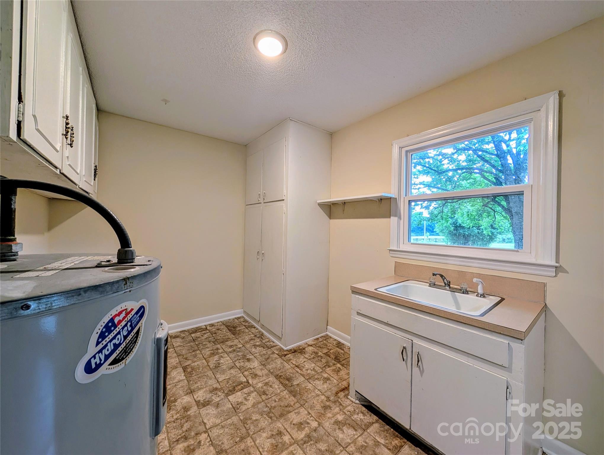 5628 White Store Road Wingate, NC 28174 - Photo 16 of 31 a bathroom with a granite countertop sink and a window