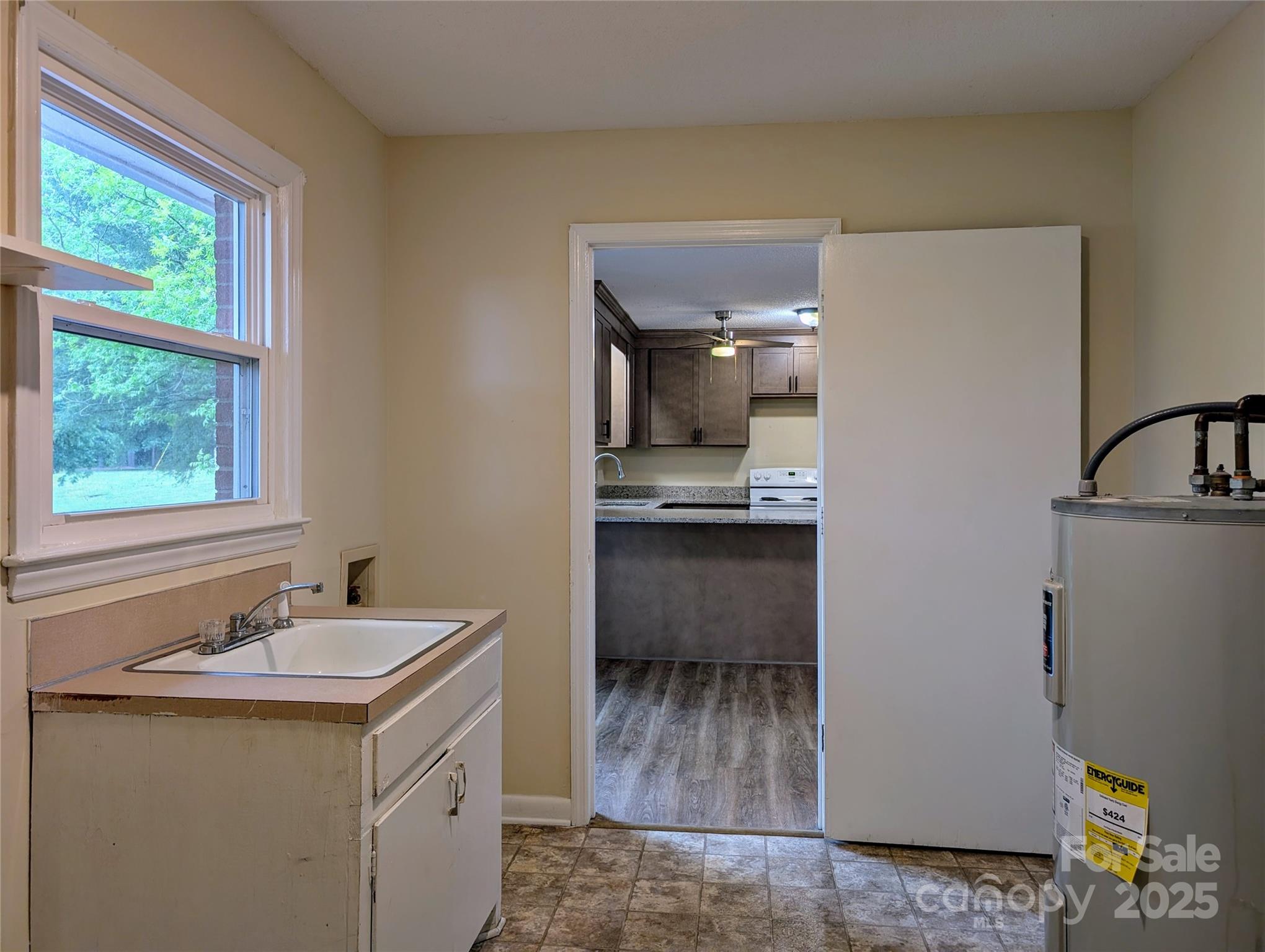 5628 White Store Road Wingate, NC 28174 - Photo 17 of 31 a kitchen with a sink cabinets stainless steel appliances and a window