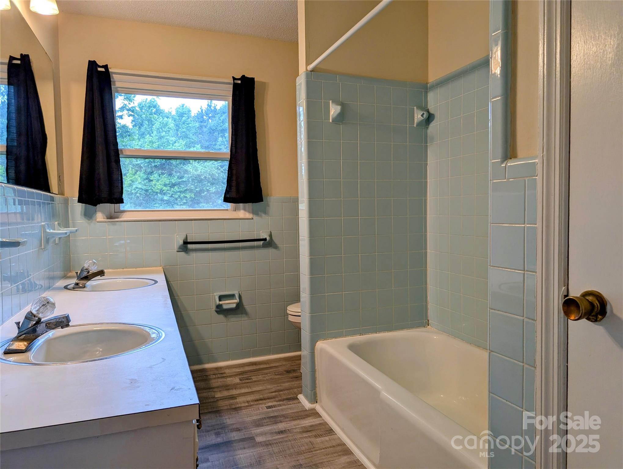 5628 White Store Road Wingate, NC 28174 - Photo 19 of 31 a bathroom with a tub a sink and a window
