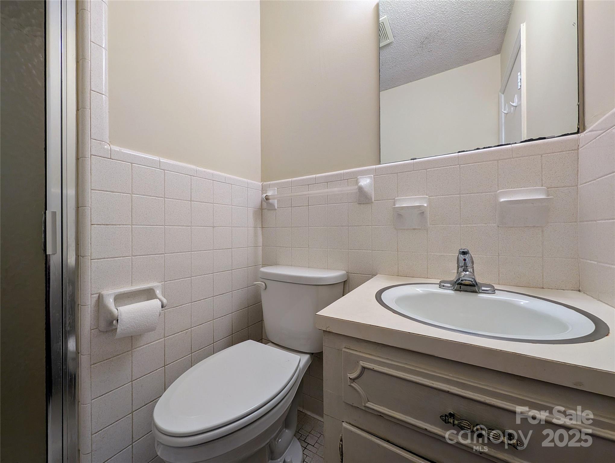 5628 White Store Road Wingate, NC 28174 - Photo 21 of 31 a bathroom with a sink a toilet and a mirror