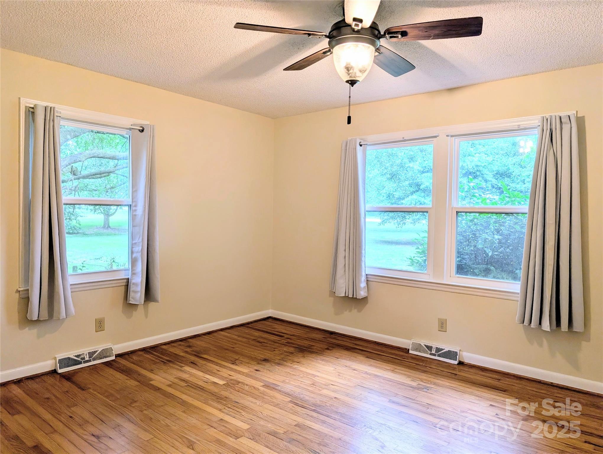 5628 White Store Road Wingate, NC 28174 - Photo 25 of 31 a view of an empty room with wooden floor and a window