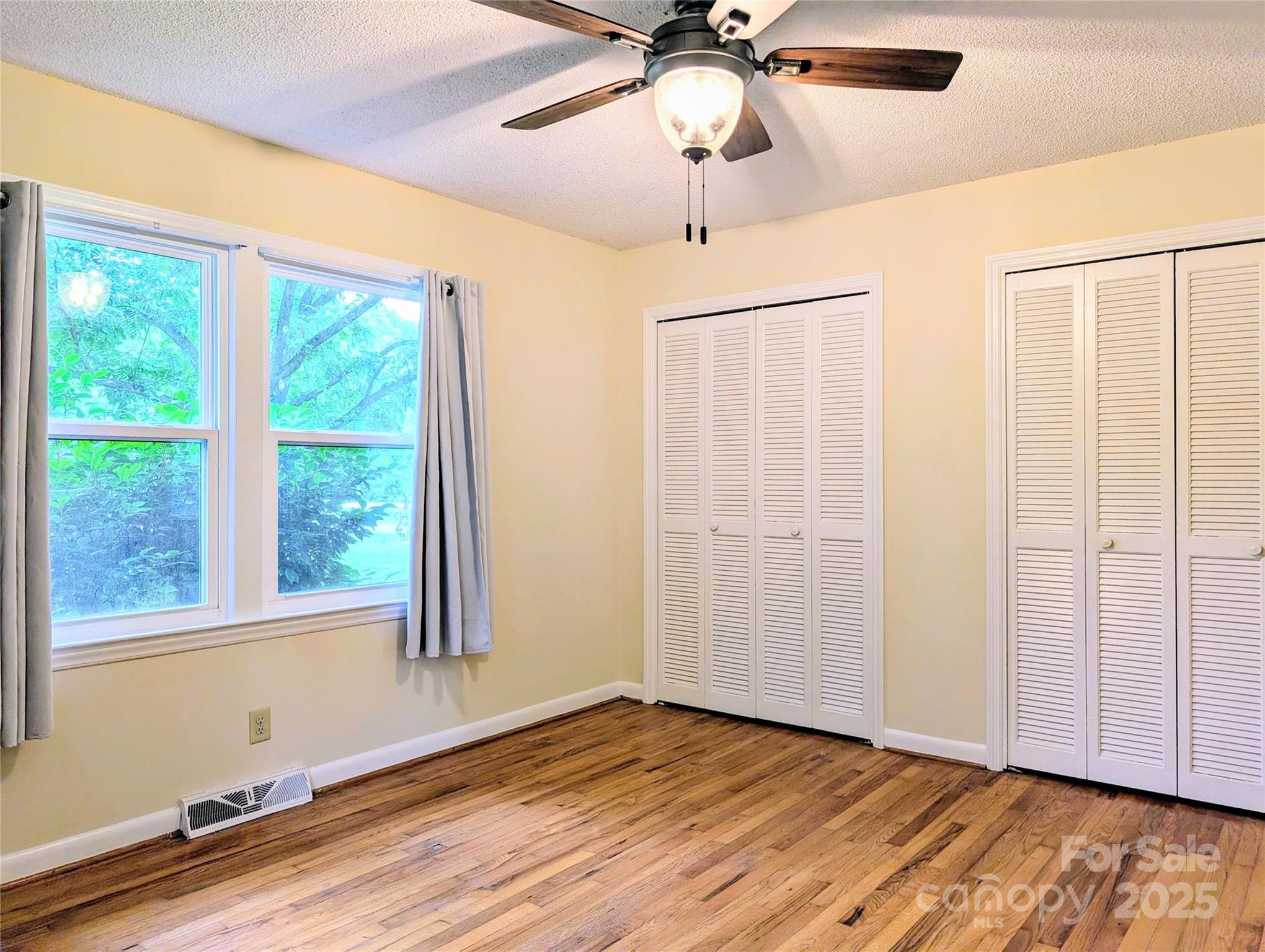 5628 White Store Road Wingate, NC 28174 - Photo 27 of 31 an empty room with wooden floor fan and windows