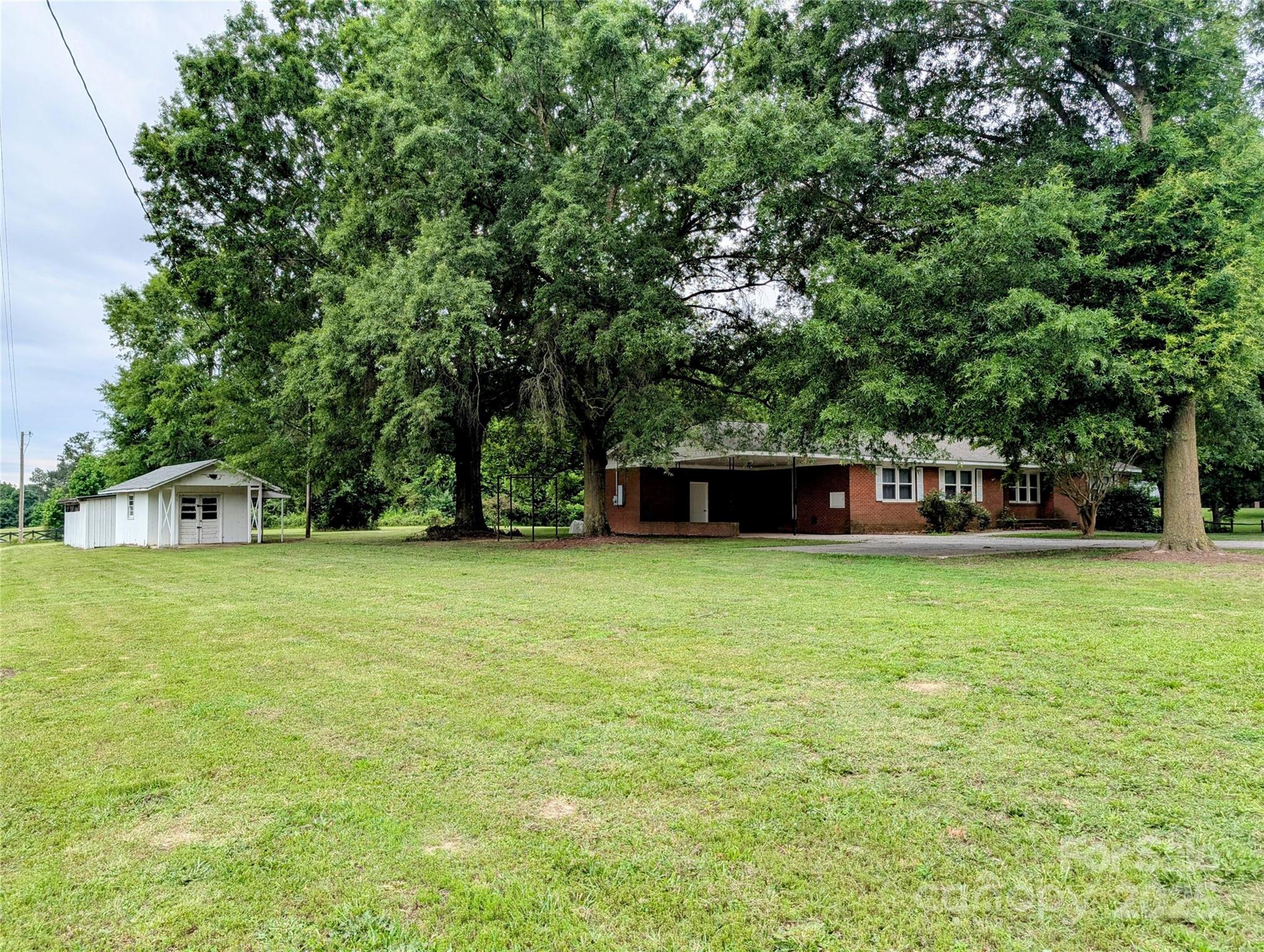 5628 White Store Road Wingate, NC 28174 - Photo 6 of 31 a front view of a house with a garden
